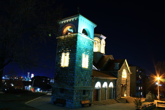 Illuminated Serbian Orthodox church with bell tower at night in Bor Serbia