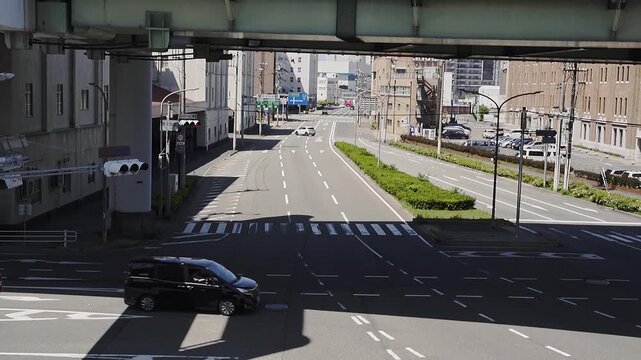 a Busy street situation in Kobe, Japan. Lot of vehicles passing by. Urban city life. Full HD slowmotion Footage. Travel or transportation concept