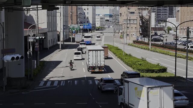 a Busy street situation in Kobe, Japan. Lot of vehicles passing by. Urban city life. Full HD slowmotion Footage. Travel or transportation concept