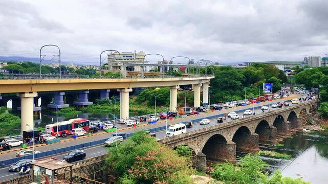 Vehicle moves along the Pune metro rail road near Sangam Bridge, now the Indian urban mass transit metro railway system.