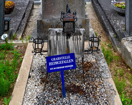 Abandoned, dilapidated, and unmarked old grave plot in an Austrian village cemetery