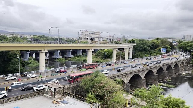 Vehicle moves along the Pune metro rail road near Sangam Bridge, now the Indian urban mass transit metro railway system.
