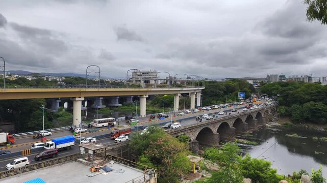 Vehicle moves along the Pune metro rail road near Sangam Bridge, now the Indian urban mass transit metro railway system.