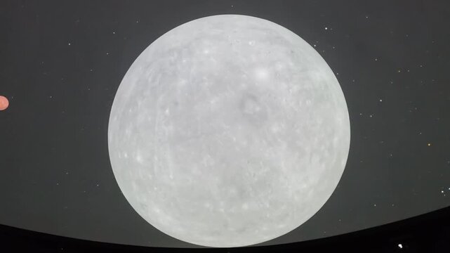 Immersive planetarium dome projection showing planet Saturn, stars constellation map and deep space universe exploration.