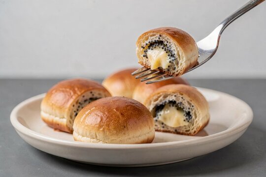 Kolace on plate, round, golden-brown, with bite revealing creamy filling. Concept of fresh, sweet buns with poppy seed cheese arranged attractively, invitingly served.