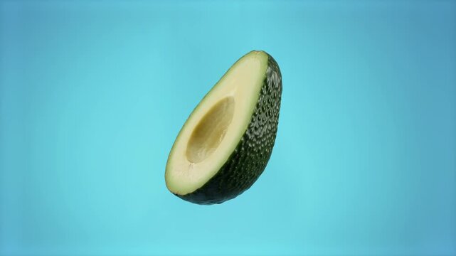 A close-up 3D animation of a ripe green avocado half without a pit slowly spinning and floating in the air. This clean, loopable food loop is perfect for healthy diet promotions, culinary recipes, org