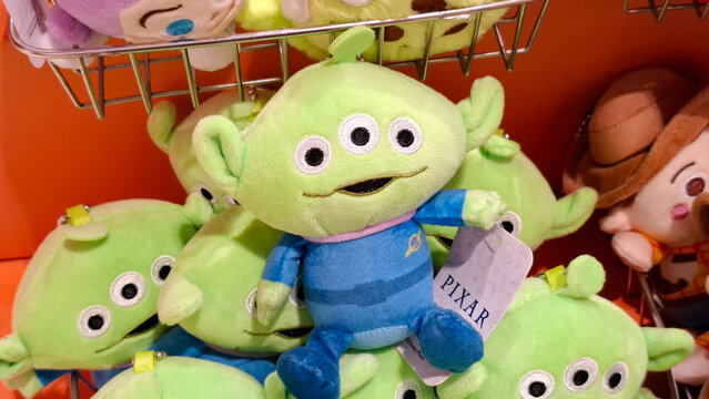 Close up shelf display of official Disney Pixar Toy Story alien plush toys with iconic three eyes and space suits at a souvenir retail shop on July 3, 2026 in Bangkok, Thailand