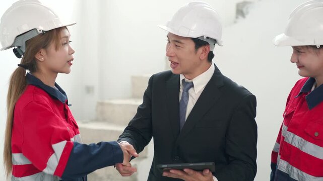 Engineer and manager handshake agreement at industrial site