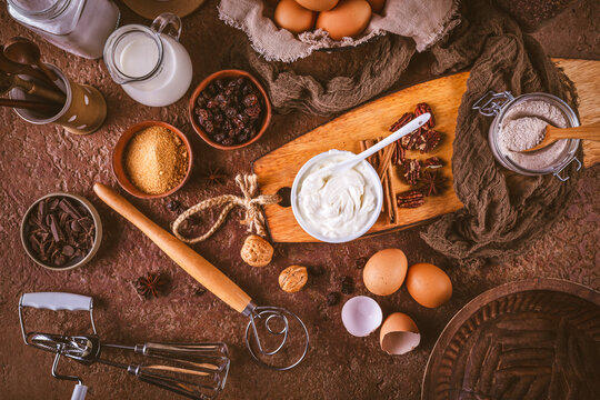 Baking ingredients and tools arranged for a rustic, homemade dessert preparation