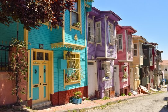 Colorful houses line a street with vibrant doors and windows