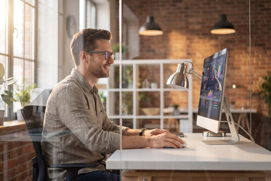 Business Professional Working at Desktop Computer in Creative Office