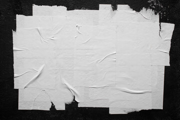 Close-up of white poster with folds.
