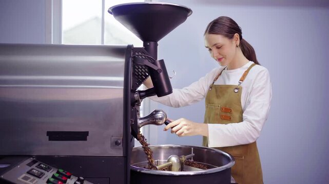 Female roaster opening drum hatch to dump beans in cooling tray