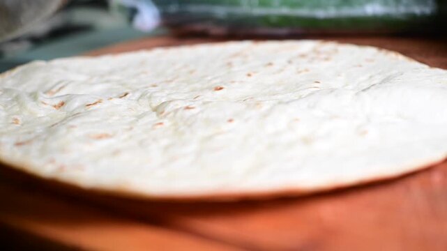 eggs fried ham breakfast burrito on hot tortilla bread close up of making the food