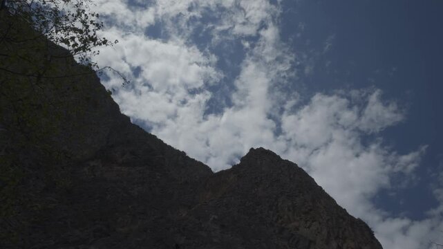 A cinematic timelapse capturing fast-moving clouds drifting above the rugged mountain cliffs of El Salto, near Monterrey, Nuevo Le&oacute;n, Mexico. Dramatic sky and towering rock formations.