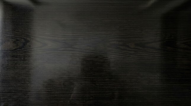 Dark ebony wood panel with fine natural grain texture