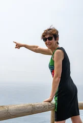 Woman pointing at ocean view at playa de las catedrales © JuanFrancisco