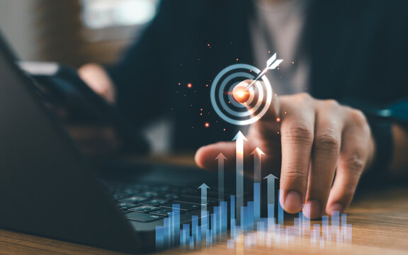 Businessperson touching virtual target icon with growing financial graph chart. Concept of business goal achievement, marketing strategy, investment success, and objective