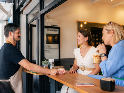 Grateful guests thanking barista for service 