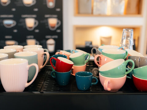 Coffee Mugs and Cups Arranged on a Machine shelf in a Cafe Setting