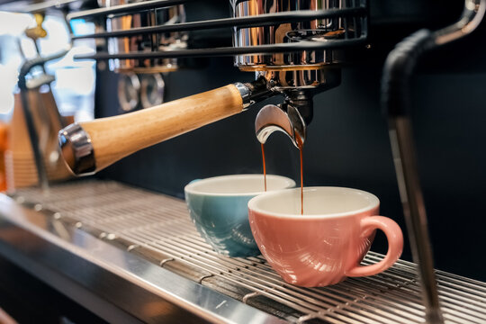 Coffee pouring into cup through portafilter 