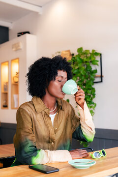 Woman enjoying her morning coffee at cafe 