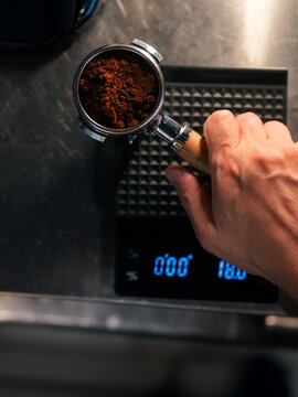 Barista Measures Coffee Grounds on Scale in Cafe