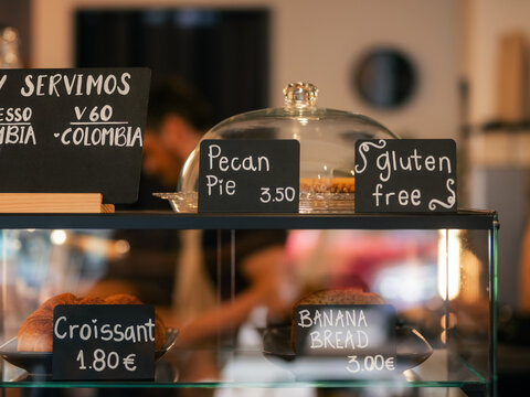 Bakery Display Shows Various Baked Goods and Prices in a Cafe
