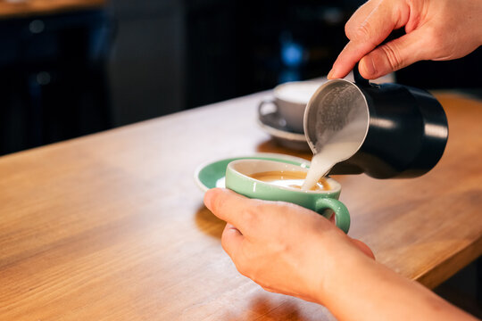 Barista making latte at work 