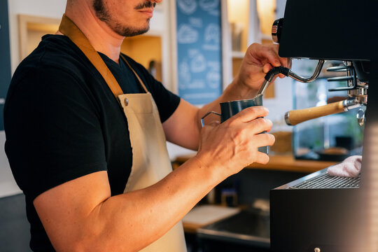 Barista Prepares Coffee Drinks in a Cafe 