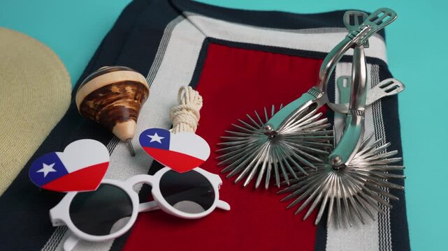 Chilean patriotic items, including spurs, a poncho, and flag-themed glasses, celebrating culture