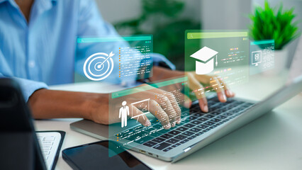 person typing on laptop keyboard with virtual icon interface for e-learning, online education, business training course, professional growth and upskilling concept. © Ao Zaa Studio