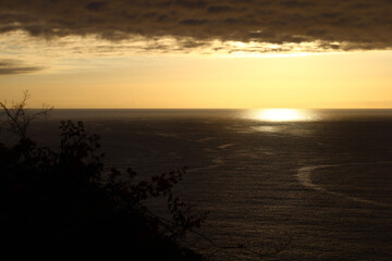 Dark clouds above the Atlantic Ocean with bright sunset reflection © Gabriela