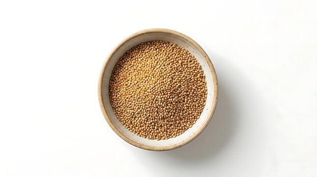 A top-down view of a ceramic bowl filled with raw camelina sativa seeds, highlighting the small, golden-brown oilseed grains isolated on white background