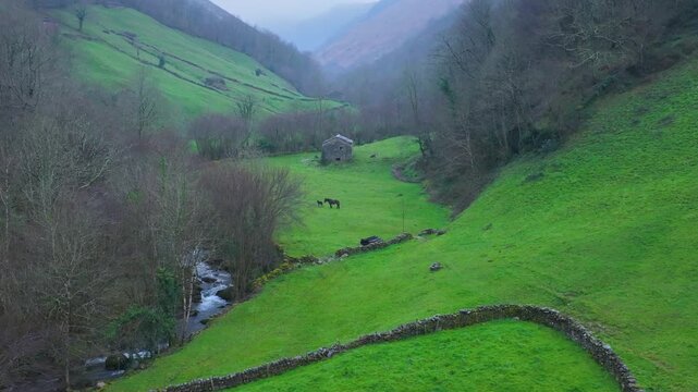 Aerial view from a drone of the winter landscape around the village of Vega de Pas. Pasiegos Valleys region, Cantabria, Spain, Europe