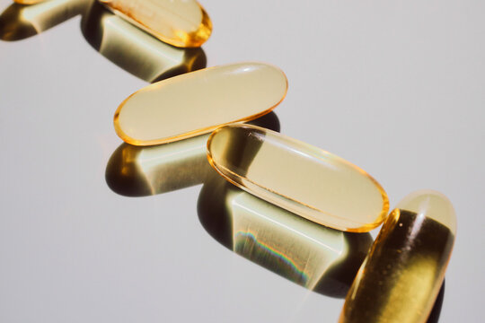 Golden gel capsules showing dietary supplement for wellness and healthcare