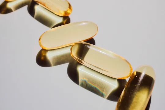 Golden gel capsules showing dietary supplement for wellness and healthcare