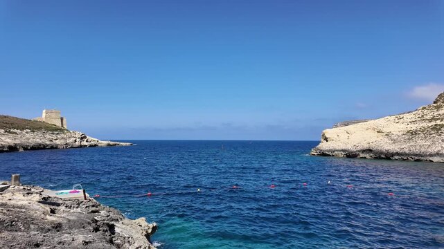 Rugged coastline, and calm sea in a sunny day in Xlendi bay, Munxar, Gozo,Malta. High quality 4k footage