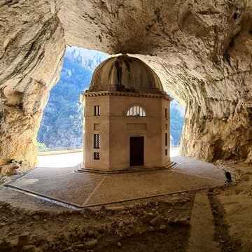 Tempietto del Valadier, Genga, Marche, Italy. Historic domed chapel inside a natural cave near Frasassi Gorge, surrounded by dramatic limestone rock walls.