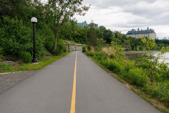 Riverside Ottawa River Pathway leading toward Parliament Hill and Supreme Court building in Canada