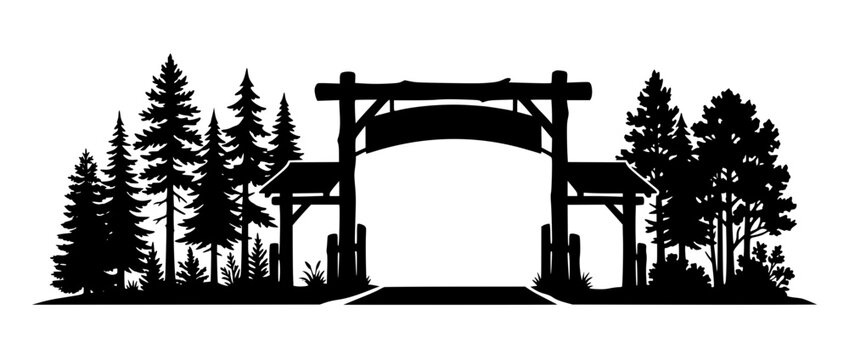 Silhouette of a rustic wooden park entrance gate surrounded by pine trees