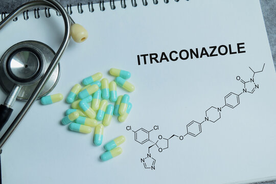 Concept of itraconazole antifungal write on book isolated on Wooden Table. For fungal infection treatment and prescription healthcare therapy