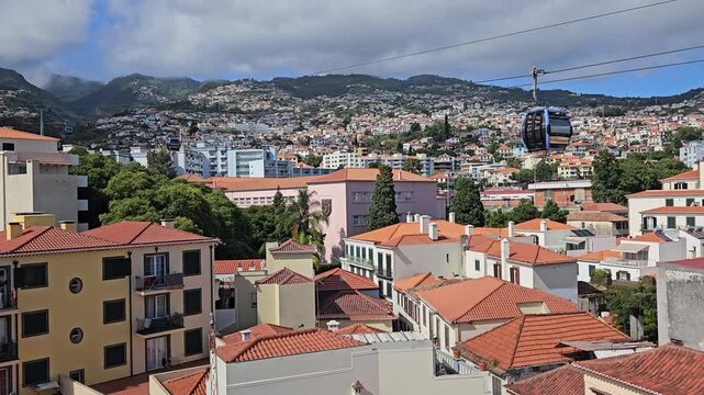 Funchal Cable Car soaring above Santa Maria Maior and Zona Velha rooftops, Madeira, Portugal