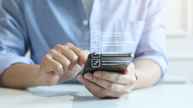 close up man hand use smartphone to check online survey and questionnaire from website for marketing concept