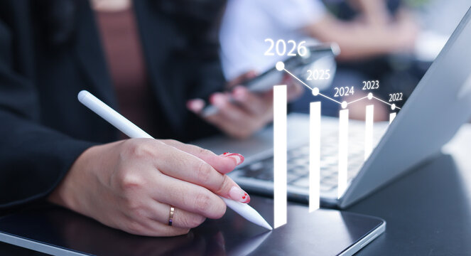 close up manager businesswoman write and think strategy of business profit with virtual statistic graph for new year 2026 target and financial forecasting in office room concept