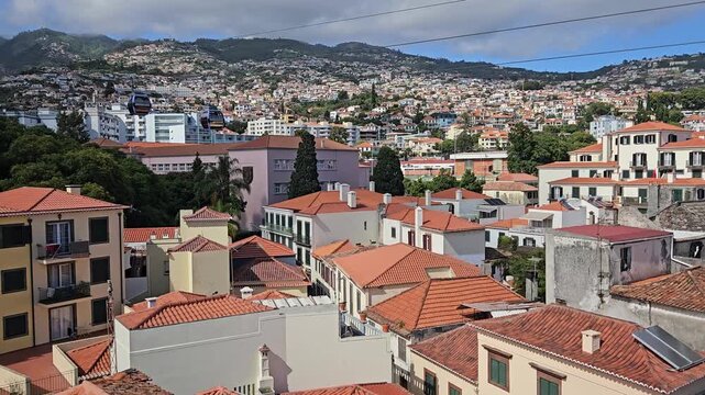 Funchal Cable Car soaring above Santa Maria Maior and Zona Velha rooftops, Madeira, Portugal
