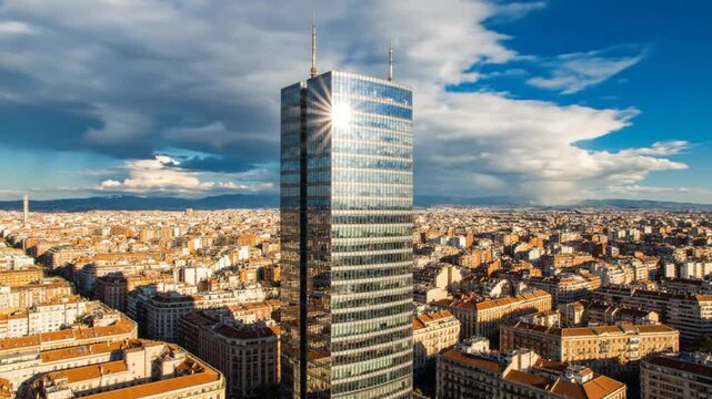 High-Angle Perspective of a Modern Glass Skyscraper Reflecting Sunlight in a Dense Urban Cityscape