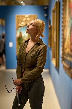 Caucasian woman looking at exhibition