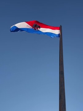 The Croatian flag waving on the wind, Hvar island, Croatia .Blue sky in the background.Patriotic Symbol. Slow motionFullHD footage