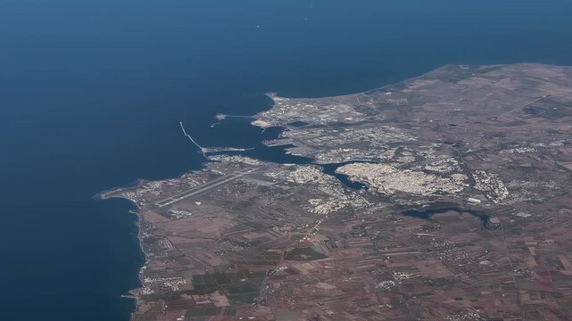 flying along Italian coast of the Adriatic Sea with Brindisi, a city in the region of Apulia in southern Italy, with Brindisi Papola Casale Airport, Cityscape and Brindisi Harbor - 4k aerial footage